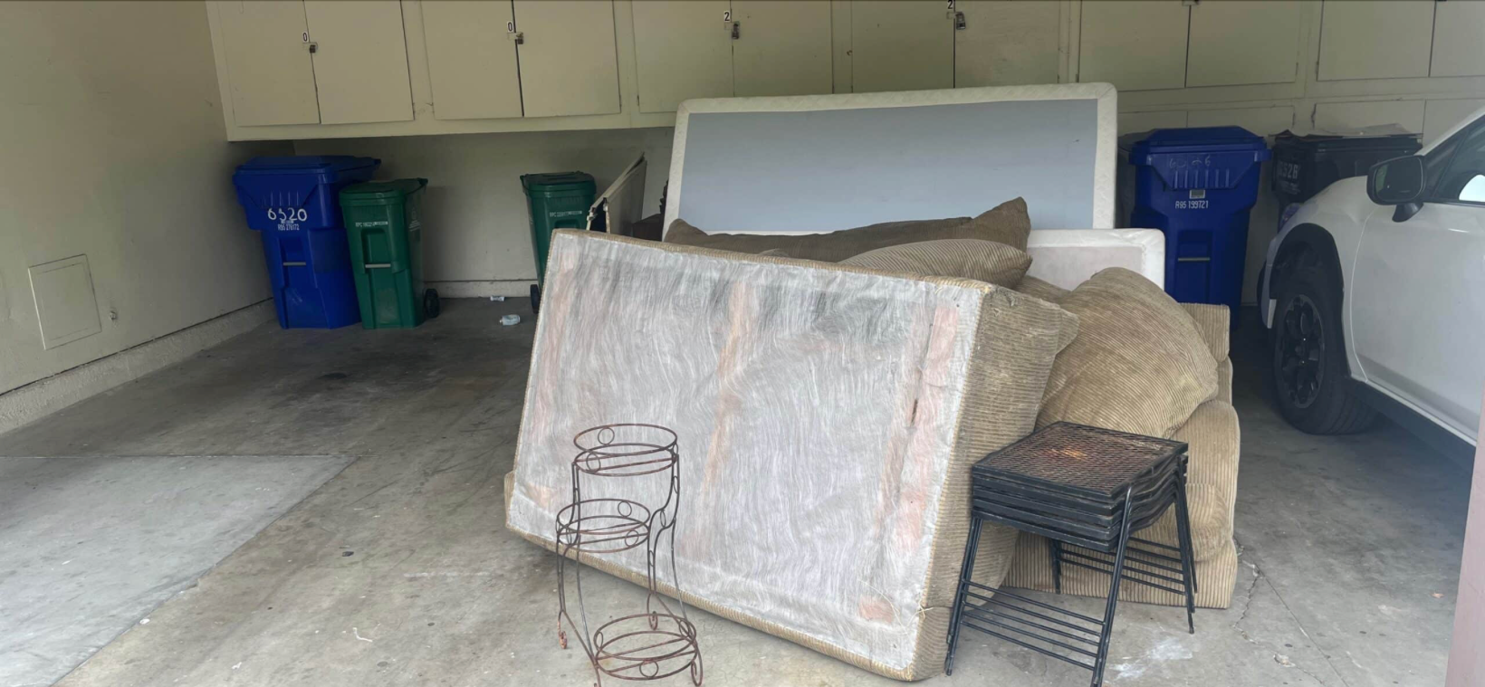 Garage full of old furniture before junk removal