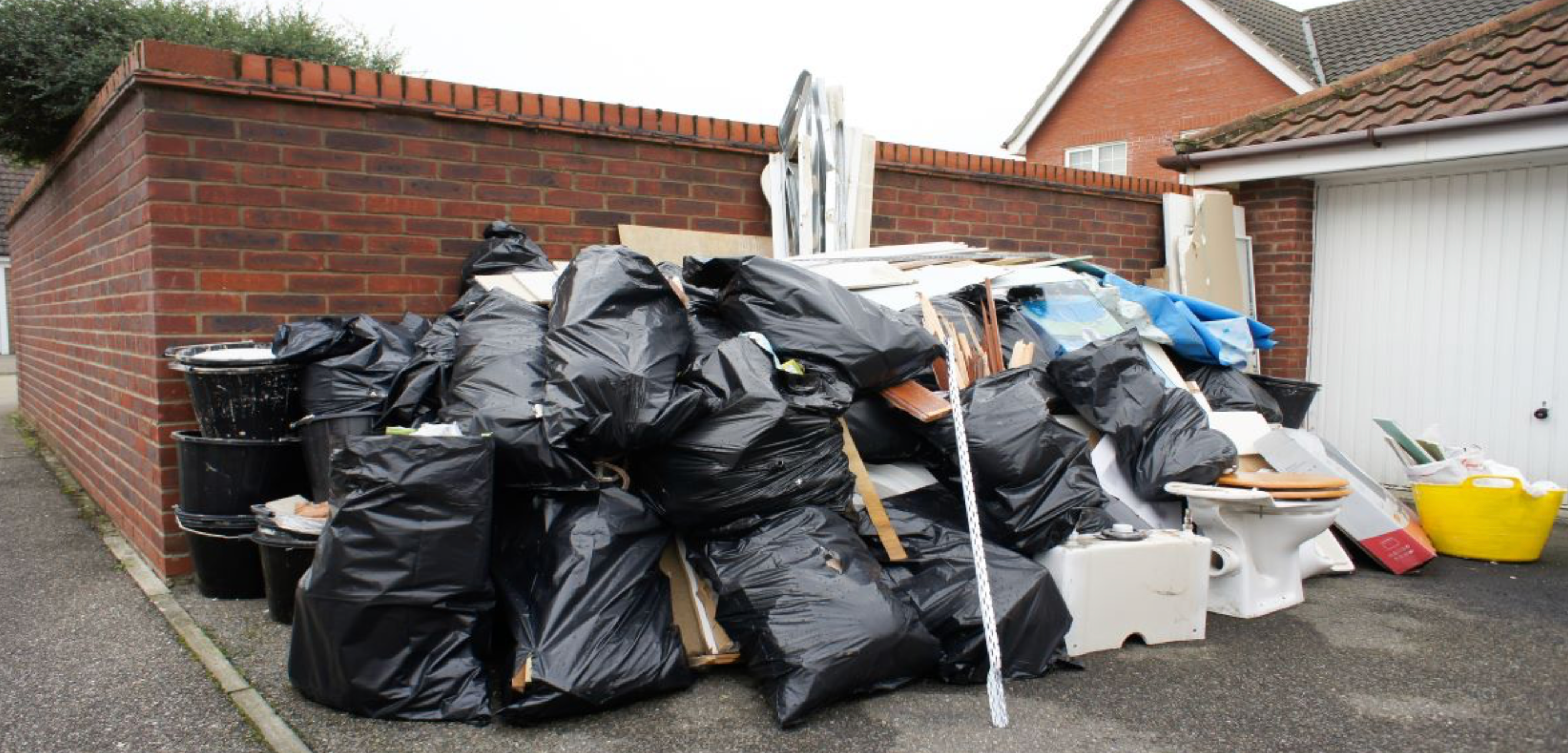 Renovation debris and bagged waste ready for pickup